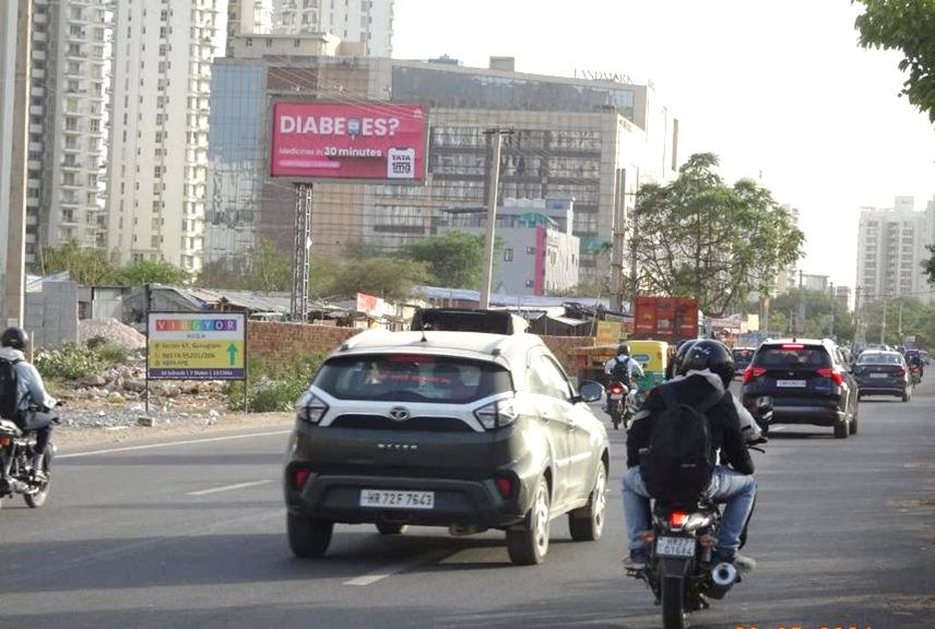 Highway hoarding advertising in Gurugram showcasing brand visibility along a busy highway, managed by leading advertising companies for maximum exposure.