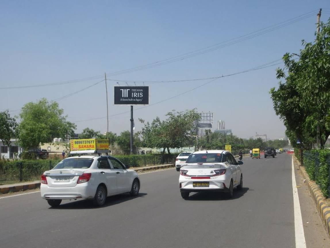 Highway hoarding advertising in Gurugram showcasing brand visibility along a busy highway, managed by leading advertising companies for maximum exposure.