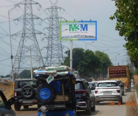 Large roadside hoarding in Gurugram showcasing an advertisement by a leading hoarding company.