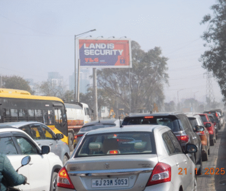 Large roadside hoarding in Gurugram showcasing an advertisement by a leading hoarding company.