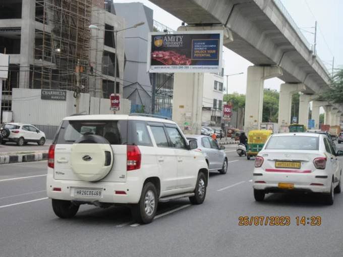 Large outdoor Unipole by Acme Advertiser displayed on a busy roadside, showcasing high-impact hoarding advertising for brand visibility in urban India.