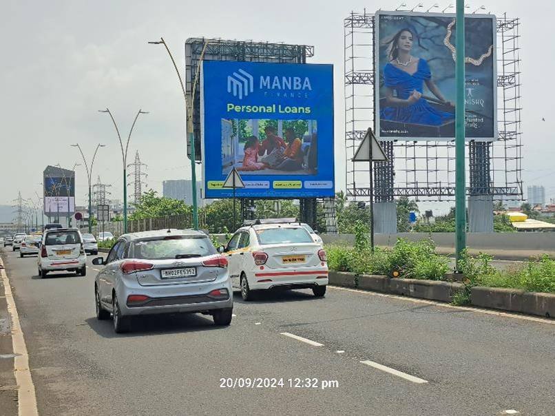 Street view of branded displays by leading Pole Kiosk Advertising Companies in Mumbai on a busy urban road with consistent foot and vehicle traffic