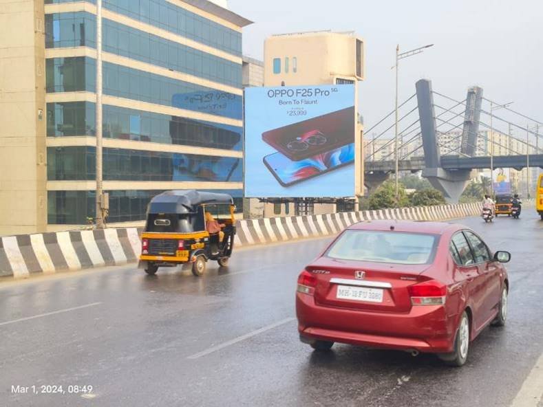 Street view of branded displays by leading Pole Kiosk Advertising Companies in Mumbai on a busy urban road with consistent foot and vehicle traffic