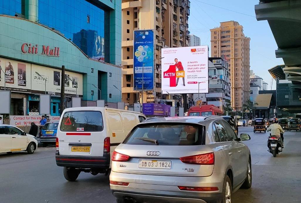 Outdoor advertising display by ACME Advertising Co. featuring a bold brand campaign on a busy urban street. Unipole advertising companies in Mumbai showcasing a large outdoor billboard on a busy road with high traffic visibility