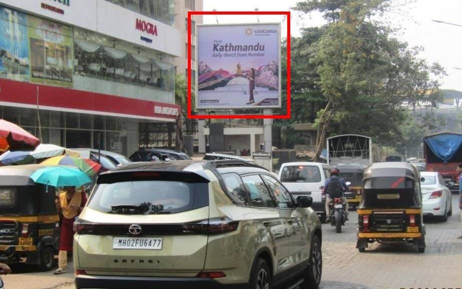 Outdoor advertising display by ACME Advertising Co. featuring a bold brand campaign on a busy urban street. Unipole advertising companies in Mumbai showcasing a large outdoor billboard on a busy road with high traffic visibility