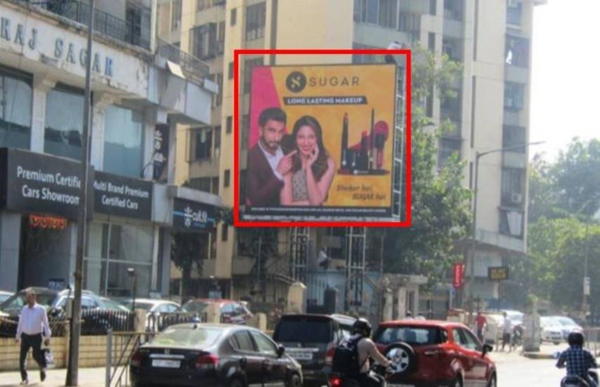 Outdoor advertising display by ACME Advertising Co. featuring a bold brand campaign on a busy urban street. Unipole advertising companies in Mumbai showcasing a large outdoor billboard on a busy road with high traffic visibility