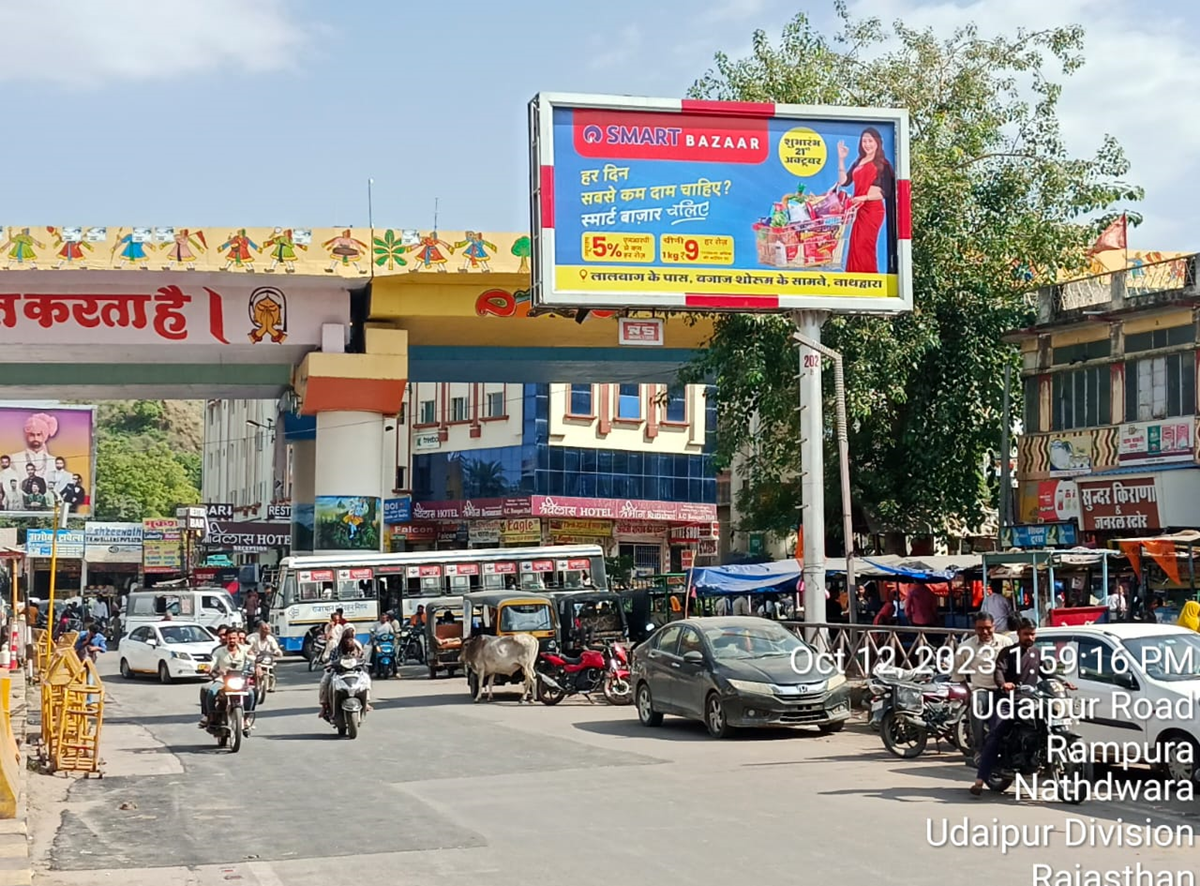 Large roadside billboard in Rajasthan displaying a vibrant brand advertisement, placed in a high-traffic urban area, showcasing the work of leading billboard advertising companies in Rajasthan. Large roadside billboard in Rajasthan displaying a vibrant brand advertisement, placed in a high-traffic urban area, showcasing the work of leading billboard advertising companies in Rajasthan.