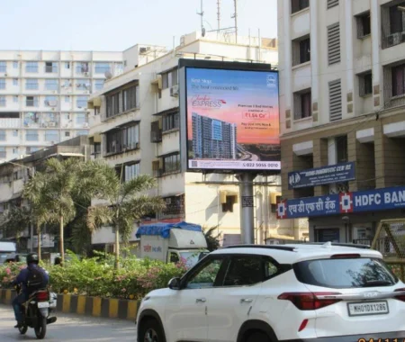 Digital billboard in Mumbai promoting a premium residential real estate project, placed at a busy street corner near HDFC Bank and residential buildings.
