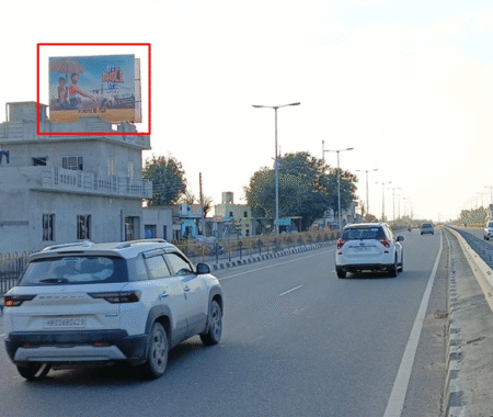 Phagwara Entry Chandigarh Highway with 20x15 ft hoarding by ACME Advertising Co., mounted on roadside building; visible vehicles, lane divider, and under construction structure
