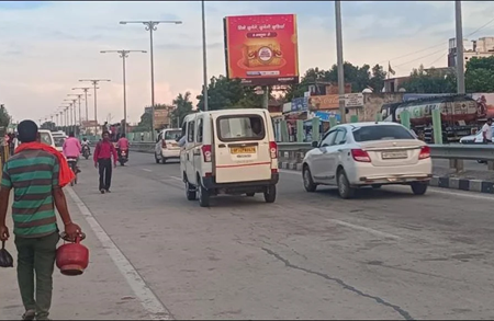 Lucknow city road with 20x10 ft Patanjali food hoarding by ACME Advertising Co.; visible van, pedestrians, and urban traffic scene