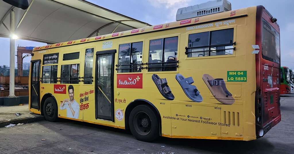 Electric city bus advertising footwear brand through high-visibility Bus Branding Services