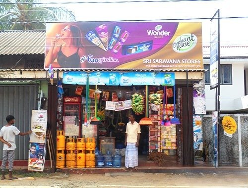 Dealer boards advertising at Sree Saravana Stores featuring Wonder brand signage for neighbourhood retail visibility