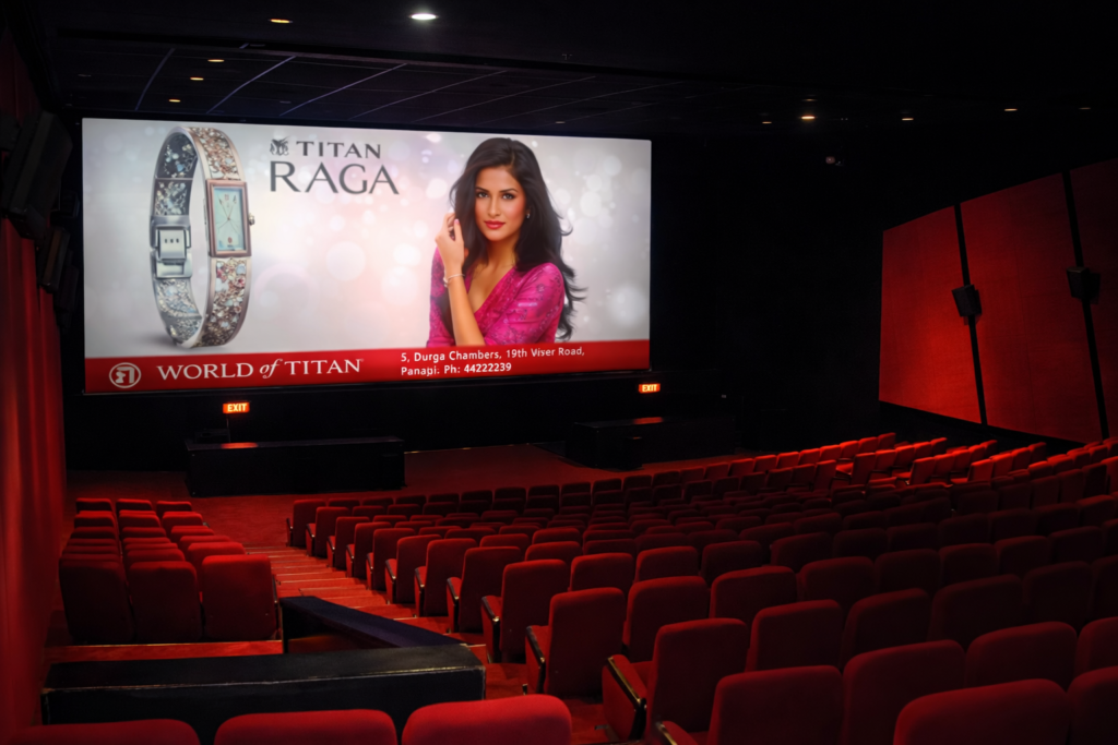 Cinema ads displayed on a large movie screen inside a premium multiplex theatre during a film screening