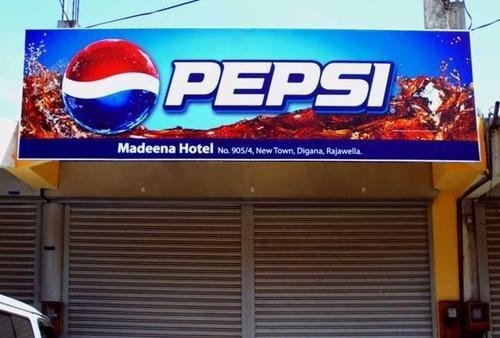 Non-Lit Board Advertising featuring a Pepsi dealer board placed above a retail shop entrance