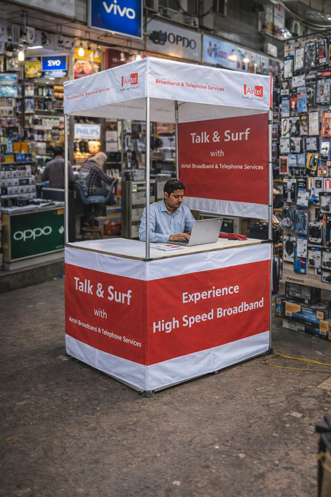 Canopy advertising stall promoting Airtel broadband services in a busy retail market