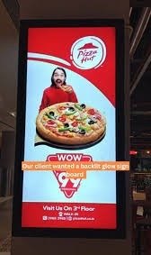 Glow Sign Board Advertising featuring a vertical Pizza Hut illuminated sign to attract attention in high-footfall areas