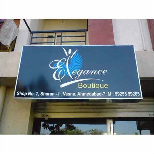 Flex Board Advertising mounted above boutique storefront displaying brand name and location details clearly