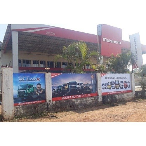Flex Board Advertising installed outside an automobile dealership showcasing vehicle range with large-format outdoor branding