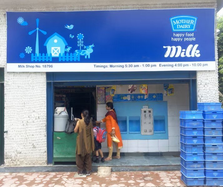 Mother Dairy dealer board advertising at a milk booth reinforcing brand trust and daily consumer visibility